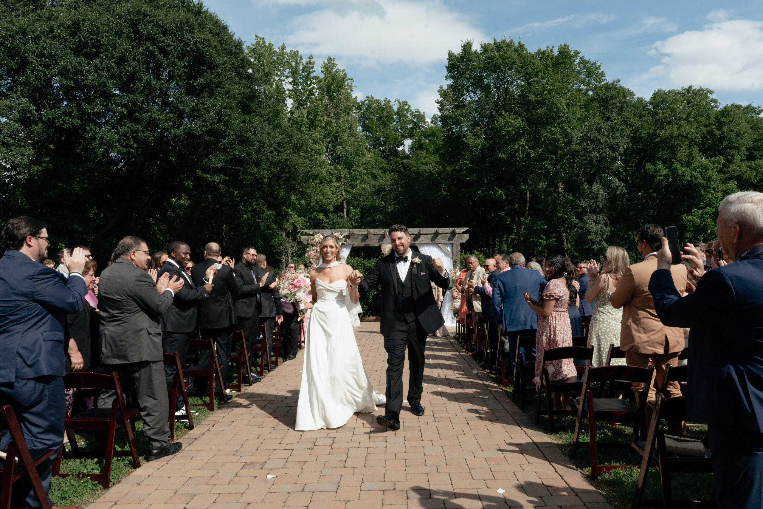 couple that just got married walking down the aisle as Mr. & Mrs.