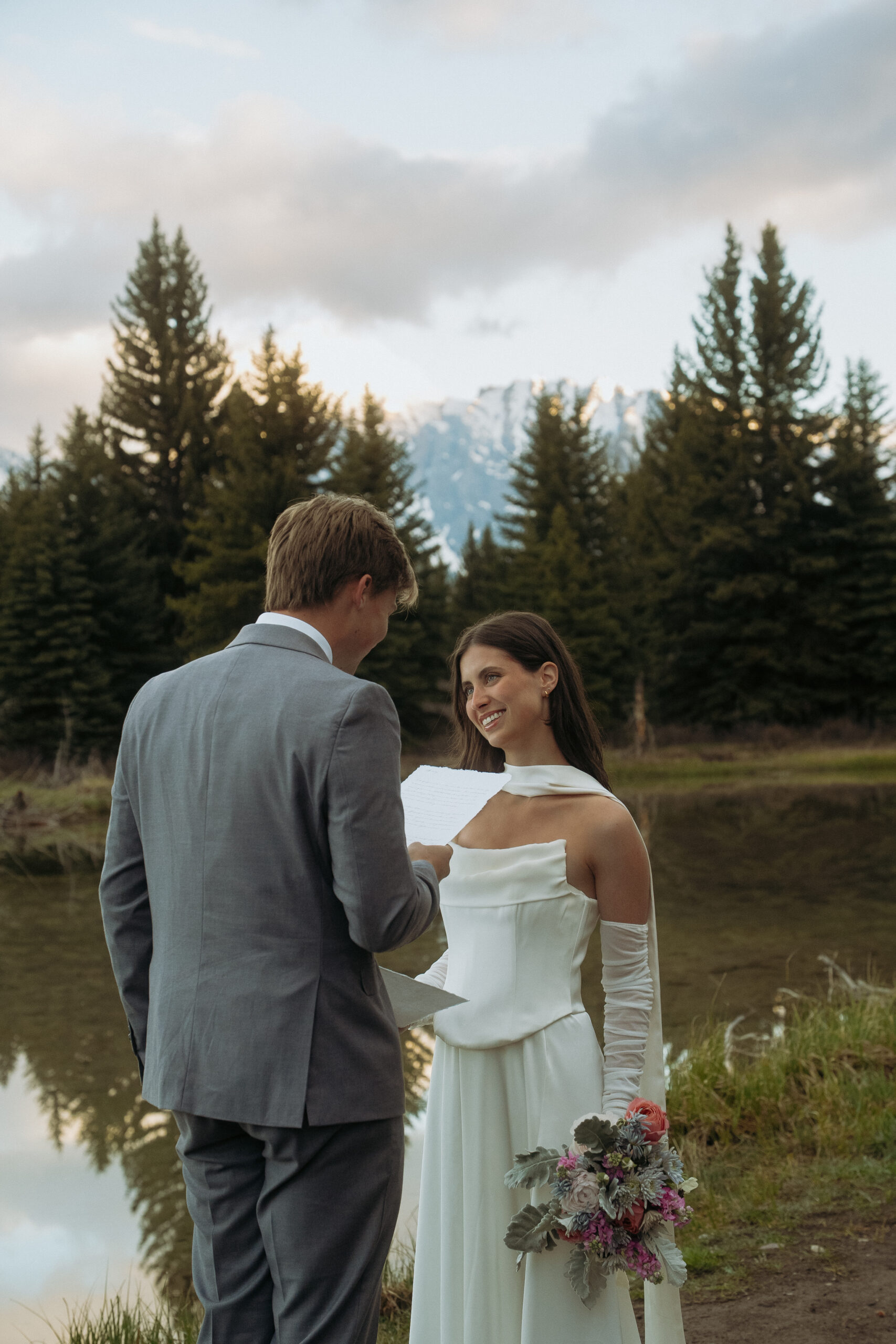 bride and groom saying their views during sunrise as the grand teton views are their backdrop.