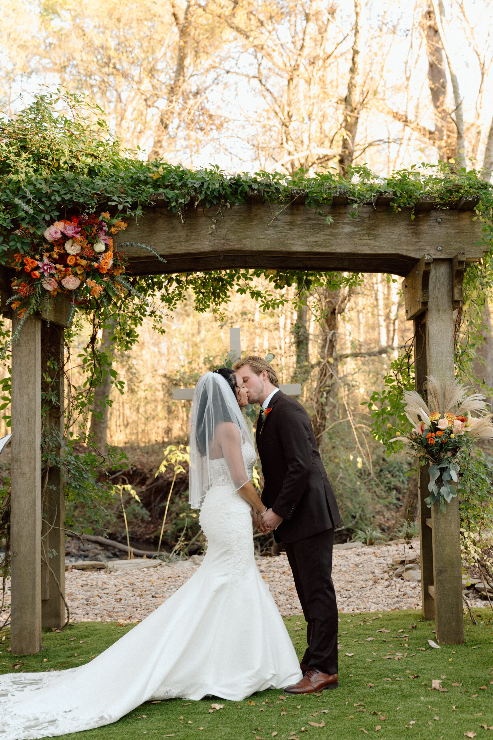 Bride and Groom Kissing At The Alter After Being Pronounced Husband And Wife
